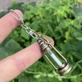 Detail of vintage bronze kerosene lamp pendant with luminous sand in nature setting - Style 5 (Tassel + Lantern)