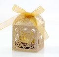 Macro shot of gold glitter cardstock gift box featuring heart-shaped hollow patterns - Glitter Rose Gold