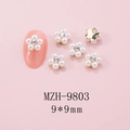Detail view of 9x9mm 3D floral nail charms with faux pearl petals and center rhinestones - 9mm Faux Pearl Gold Base Flower (9803)