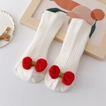 Detailaufnahme von Baby-Boden-Socken mit vertikalen Streifen und einer roten 3D-Schleife - S (0-1 Jahr) / Weiße Socken (Ball Rote Schleife)