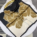 Detailed view of large square satin scarf with elegant mustard yellow floral pattern - Black