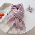 Pink cashmere-feel scarf with fringe detail and small textile label on a white background - Lavender
