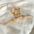 Large acetate hair claw clip with amber marble pattern and gold metal spring - Orange Blue