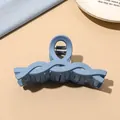 Detail of blue matte large hair claw clip with wave design on minimalist background - Light Blue Matte-Twist