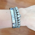 Close-up of three-piece silver stainless steel bracelet set with crown and braided texture - Triangle Beaded Crown Silver Set
