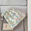 Detailed shot of floral linen tote bag with fabric brand label on a stylish chair - Simple Floral Vest Tote Style