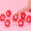 Lote de 7 juguetes tentetieso de Papá Noel rojos sobre un fondo rosa - Tentempié de Papá Noel