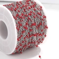 Silver stainless steel flat cross chain with red enamel beads on a white plastic spool - Steel Chain Red Beads