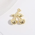 Detailed top view of a gold cherry pendant with hammer texture on a white mesh background - VD1660 Gold Smooth Hammered Cherry
