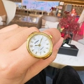 GOMIA golden quartz finger ring watch featuring a white mother of pearl dial on a finger - Gold Number 1