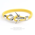 Close-up of a yellow woven bracelet with a polished silver aircraft-shaped metal clasp - Yellow Rope Silver Airplane