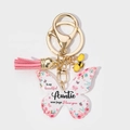 Close-up of butterfly acrylic keychain with pink floral pattern and tassel charm - Auntie