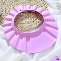 Pink adjustable baby shower cap with ear protection on straw mat background - Pink