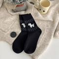 Black crew socks with white dog jacquard pattern and heart knit details in a cozy setting - One Size / Black Pony