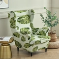 Elastic wingback chair cover featuring a vibrant green monstera leaf botanical pattern - Green Leaf