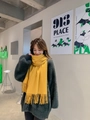 Cozy yellow cashmere scarf with fringes, warm winter wrap worn by a female model - Tassel Style / 260g (200x70cm) / Turmeric