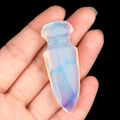 Opalite dagger carving with blue and purple iridescent glow held in hand - Opal (Synthetic)