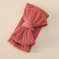 Detail of baby headband featuring soft cable knit texture and large double bow in dusty rose - Brick Red