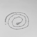 Detailed close-up of a silver stainless steel bead necklace featuring a lobster clasp and chain - Steel Color Cross Bead Chain