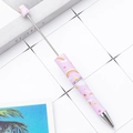 Pink beaded ballpoint pen featuring rainbow and star patterns on a white grid background - Pink with Rainbow and Stars (17)