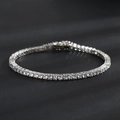 Classic silver tennis bracelet featuring brilliant round cubic zirconia on a dark background - Width 3mm/Length 18cm / White Gold