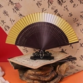 Traditional Chinese folding fan with brown bamboo frame and amber gradient silk surface - 42 Square Gradient Gold