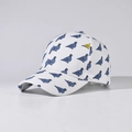 Close-up of baseball cap featuring blue pigeon prints and one yellow bird on white fabric - Adjustable / White Pigeon Print