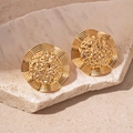 Detail view of gold geometric earrings with hammered metal texture on a stone pedestal - Gold Lava Texture Round Stud Earrings (Silver Earring Post)