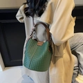 Dark green woven bucket bag with leather handle and decorative silk scarf detail - Green