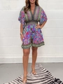 Detailed view of women's V-neck floral jumpsuit with bohemian patterns and bell sleeves - Purple