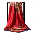 Detail of red floral satin scarf with navy border hanging on a display stand - Red Base Large Floral (027)