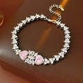 Detail of silver bracelet featuring pink heart zircons and elegant bow design - Pink Heart Bracelet (WB1591)