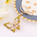Detailed macro of golden crystal butterfly keychain with sparkling yellow rhinestones - Butterfly 17