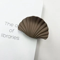 Brown marble-textured shell hair clip shown on a minimalist white book cover - Matte Rubber Coffee