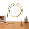 Golden round desktop makeup mirror with arch metal stand on wooden surface - Round-Gold