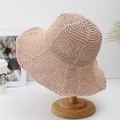 Handmade wide brim crochet sun hat for women in light pink on a wooden stand - Pink