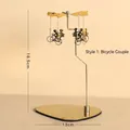 Golden spinning windmill candle holder with couple cycling pendants, 18.5cm tall - Bicycle Couple / Gold
