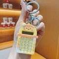 Detailed view of bubble tea calculator keychain with functional numeric keypad and orange silicone - Yellow