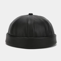 Detailed view of black faux leather texture and stitching on a minimalist docker cap - Adjustable / Black