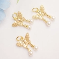 Detail of 14K gold plated butterfly pendant with hollow design and white pearls - 14K Gold Plated/White Zircon
