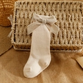 Spanish style beige knee high baby socks with a large velvet bow and ribbed texture - S 0-6 Months / Nude