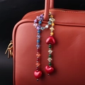 Colorful beaded strawberry bag charm with red heart beads on a red leather tote - BG00062 Colorful Beaded Bag Charm
