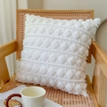 White tufted square pillowcase with geometric diamond pattern on a rattan chair - Plush Bubble Pearl White