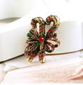 Detailed close-up of vintage gold Christmas candy cane brooch with red and green rhinestones - BR1330 Antique Gold Multicolor Candy Cane