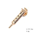 Detail of a golden syringe brooch with black scale markings and a butterfly clasp back - Gold Syringe Style