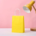 Detail of yellow kraft paper gift bag with sturdy white twisted paper rope handles - 15*11*6 / Yellow