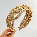 Detail shot of beige braided PU leather headband showing rich woven texture and quality - Khaki