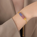 Adjustable gold snake chain bracelet with cylindrical USA flag color zircon charm - Pave Rhinestone Curved Tube Slider Style / Gold Color Bracelet (E461)