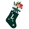 Detail of green velvet Christmas stocking with white letter L embroidery and bow - Green L