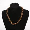 Detail of natural tiger eye crystal stone beads on a multi-layered beaded necklace - Brown Yellow/Tiger Eye